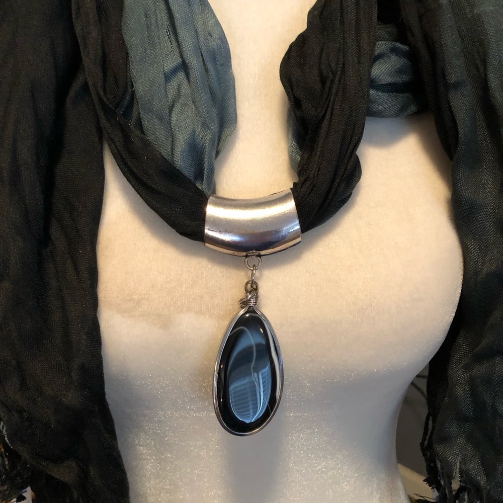 Green scarf with blue medallion in the middle